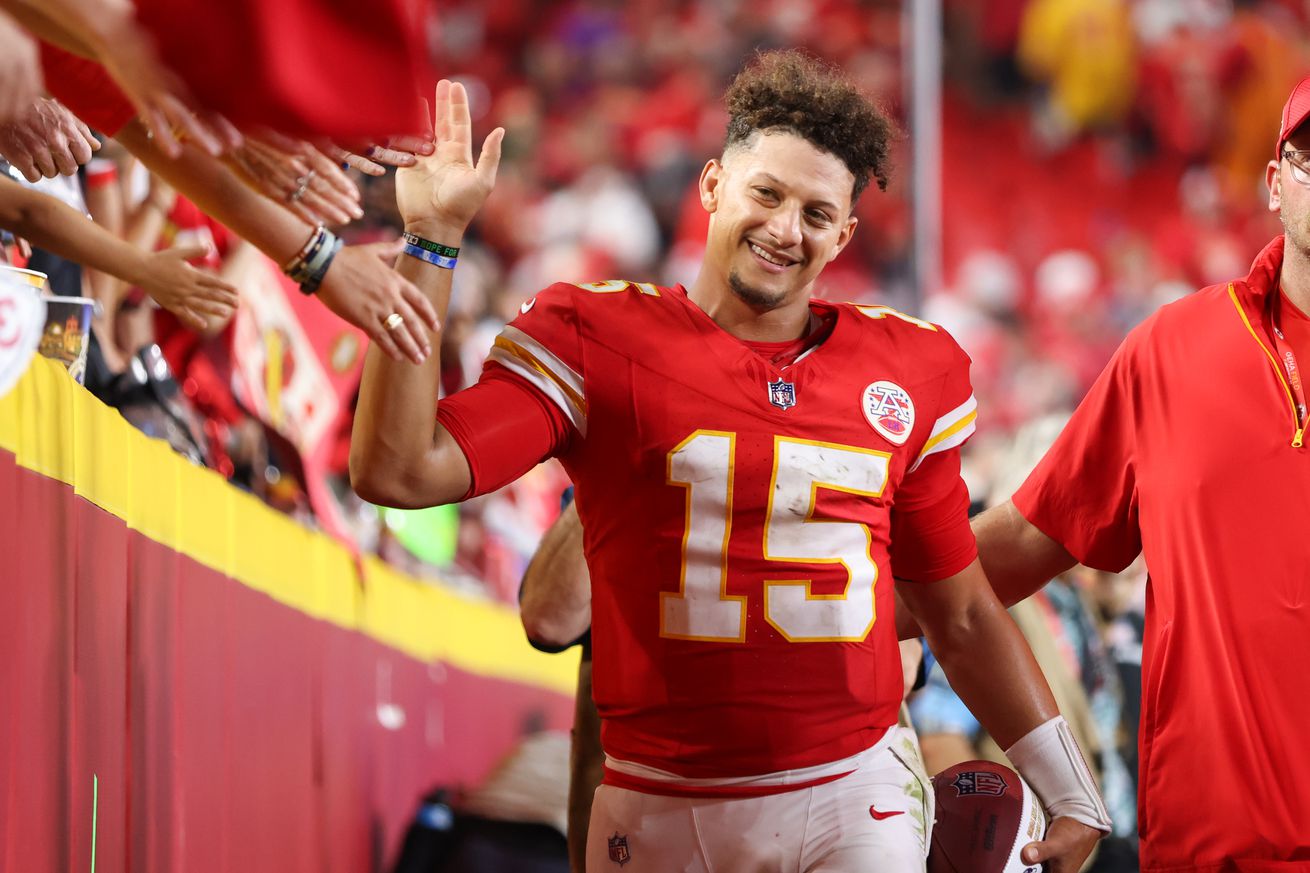 Kansas City Chiefs quarterback Patrick Mahomes (15) is all smiles as he high fives fans after an NFL game between the Baltimore Ravens and Kansas City Chiefs on September 5, 2024 at GEHA Field at Arrowhead Stadium in Kansas City, MO.