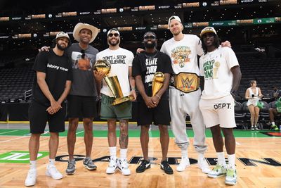 BOSTON, MA - JUNE 21: Derrick White #9, Al Horford #42, Jayson Tatum #0, Jaylen Brown #7, Kristaps Porzingis #8, and Jrue Holiday #4 of the Boston Celtics pose for a photograph with the Larry O’Brien Trophy and the Bill Russell Finals MVP Trophy before the 2024 Boston Celtics championship parade.