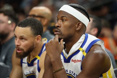Jimmy Butler III #10 and Stephen Curry #30 of the Golden State Warriors watch from the bench during the second half of the NBA game against the Phoenix Suns at PHX Arena&nbsp;